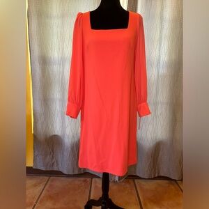 Coral dress with see-through sleeves and button cuffs